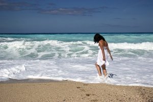 Girl playing by the beach